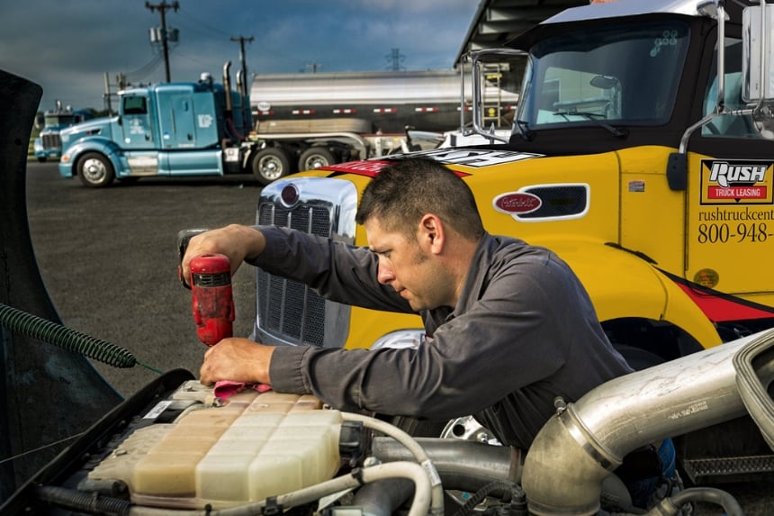 Mobile service technician working on truck