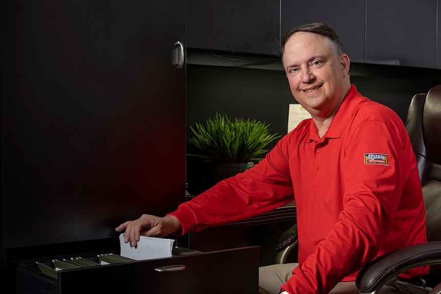 Rush Truck Leasing employee taking document out of filing cabinet